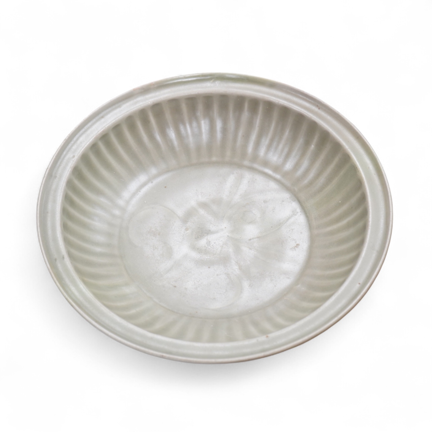 A 17th century Chinese celadon dish decorated in low relief, restored, 36cm in diameter